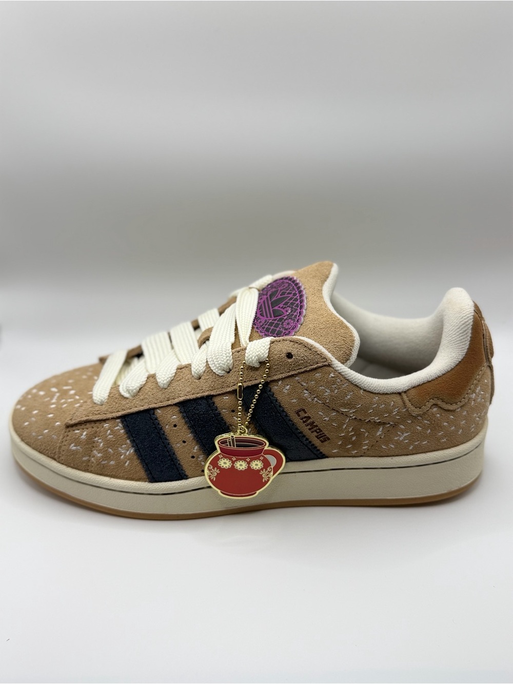 Adidas ‘Pan de Muerto’ 
Tan Suede Sneakers with Black Stripes and Red Charm